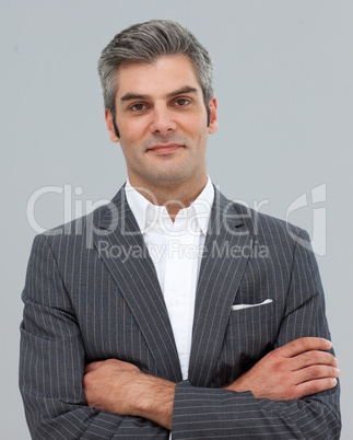 Confident businessman with folded arms