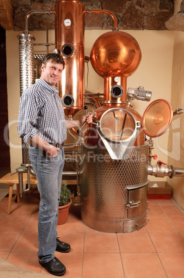 Man in front of distillery - copper
