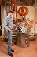 Man in front of distillery - copper