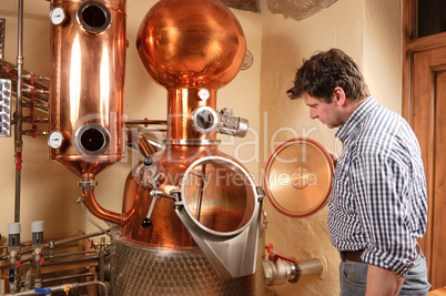 Man in front of distillery - copper