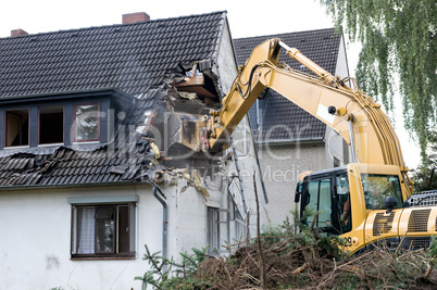 Digger demolishing house