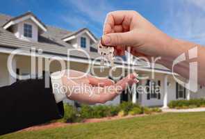 Handing Over the House Keys in Front of New Home