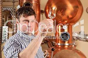 Man in front of distillery - copper