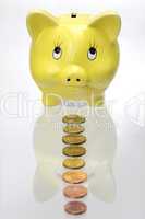 Piggy bank with Euro coins in a line