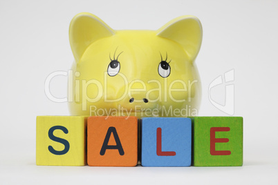 Piggy Bank with letters spelling sale