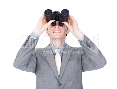 businessman looking up through binoculars