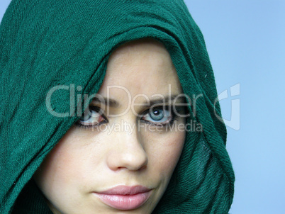 blue-eyed girl in a green linen cape