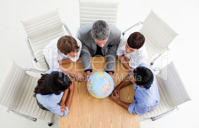 business people around a terrestrial globe