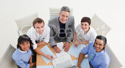 High angle of a positive business team studying a document