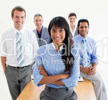 Smiling co-workers standing around a table