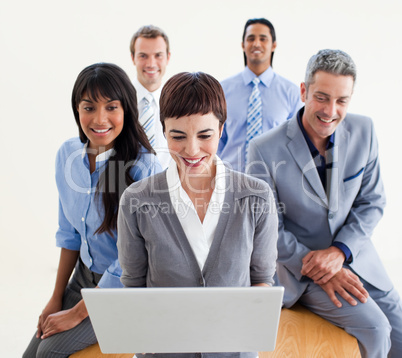 Confident business people using a laptop