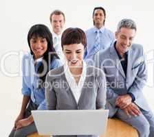 Confident business people using a laptop