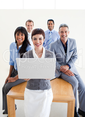 Smiling business people using a laptop