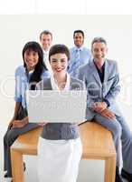 Smiling business people using a laptop