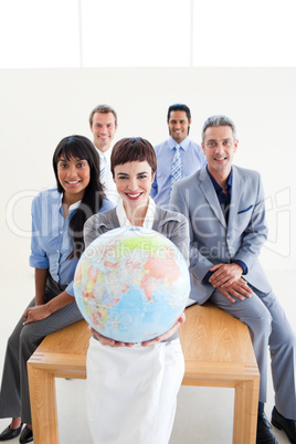 Confident business people holding a terrestrial globe