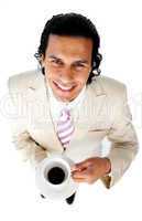 Smiling ethnic businessman drinking a coffee