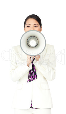 Attractive businesswoman yelling through a megaphone