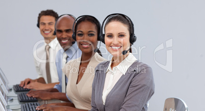 Young business people with headset on smiling at the camera