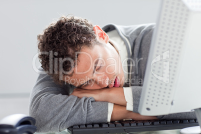 Young businessman sleeping on his desk