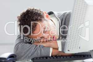 Young businessman sleeping on his desk