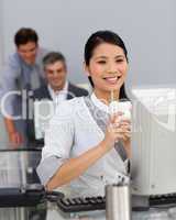 Young Businesswoman drinking a coffee at her desk