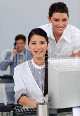 Charismatic young manager checking her employee's work
