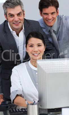 Confident business partners working together at a computer