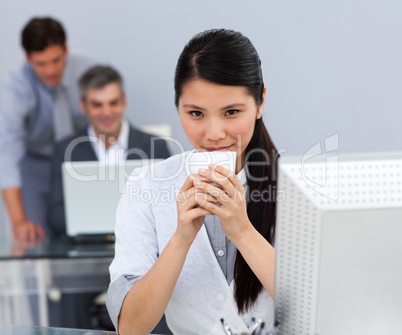 Assertive Businesswoman drinking a coffee at her desk