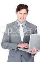 Charming businessman using a laptop