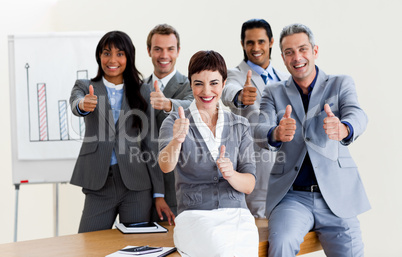 Successful business people with thumbs up