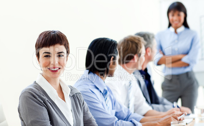 Attractive businesswoman in a meeting with her colleagues