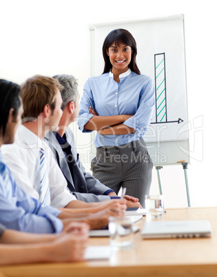 Assertive ethnic businesswoman doing a presentation to her team