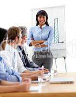 Assertive ethnic businesswoman doing a presentation to her team