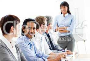 Charming businessman looking at the camera in a meeting