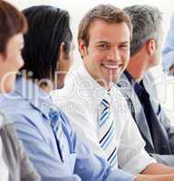 Delighted businessman looking at the camera in a meeting