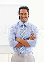 Cheerful ethnic businessman in front of a board