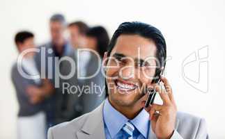 Focus on an assertive ethnic businessman on phone
