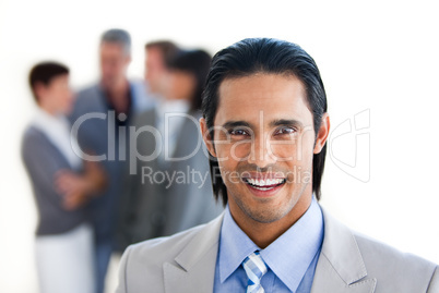 Charming businessman in front of his team