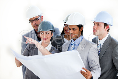 A diverse group of architects studying a plan