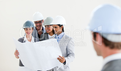 Male Engineer looking back at his smiling colleagues