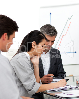 Concentrated business partners studying a document
