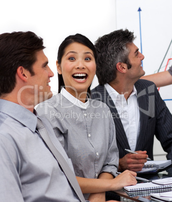 Laghing young businesswoman in a meeting