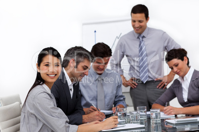 Confident young businessman presenting to his team