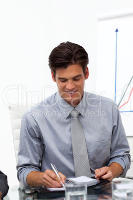 Businessman consulting his agenda in a meeting