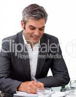 Assertive mature businessman studying a document