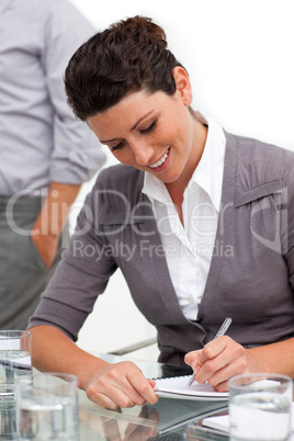 Attractive businesswoman taking notes