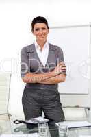 Self-assured female executive with folded arms