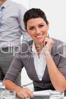 Smiling confident businesswoman taking notes