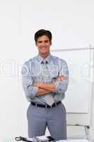Charming businessman with folded arms in front of a board