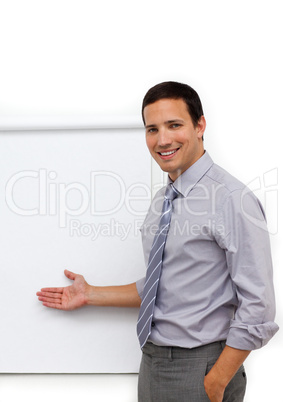 Assertive young businessman pointing at a board